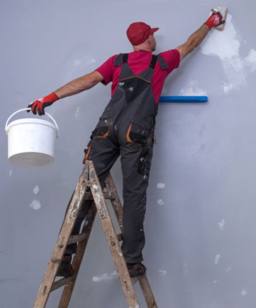 Painter preparing a wall